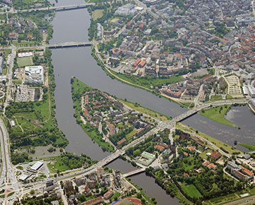 Fotografia przedstawia centrum Poznania z rzeką Wartą, z lotu ptaka. Zdjęcie pochodzi z zasobów portalu fotoportal.poznan.pl.